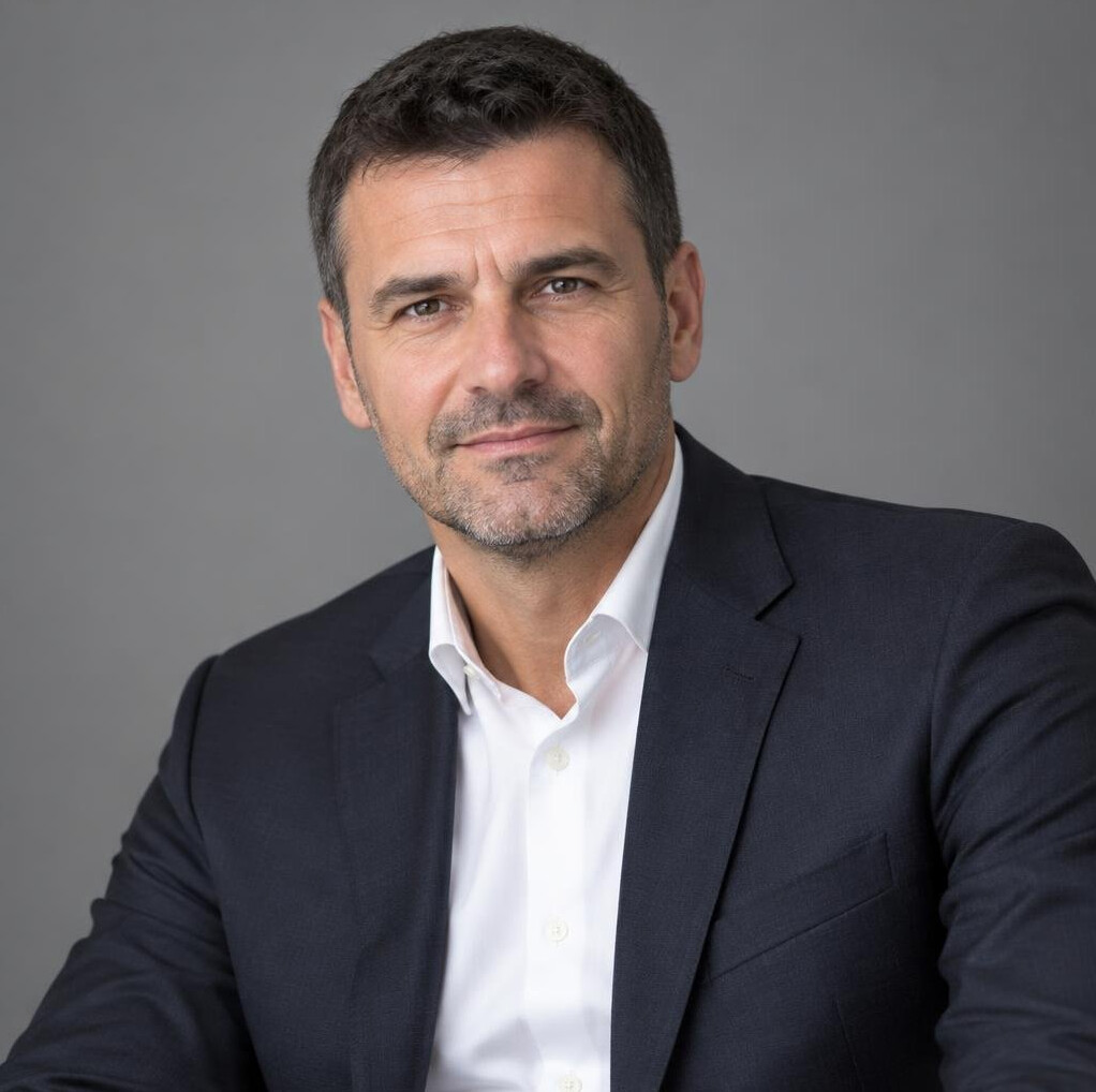 Portrait of a confident man in a dark suit with short hair