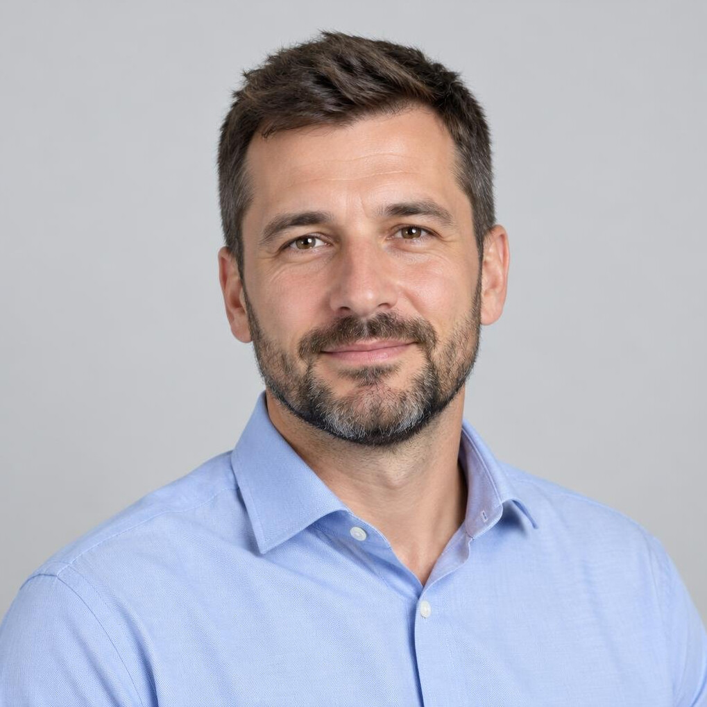 Studio portrait of a bearded man in a casual shirt